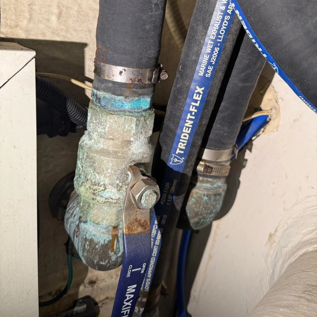 Corroded marine plumbing fittings and hoses identified during vessel maintenance