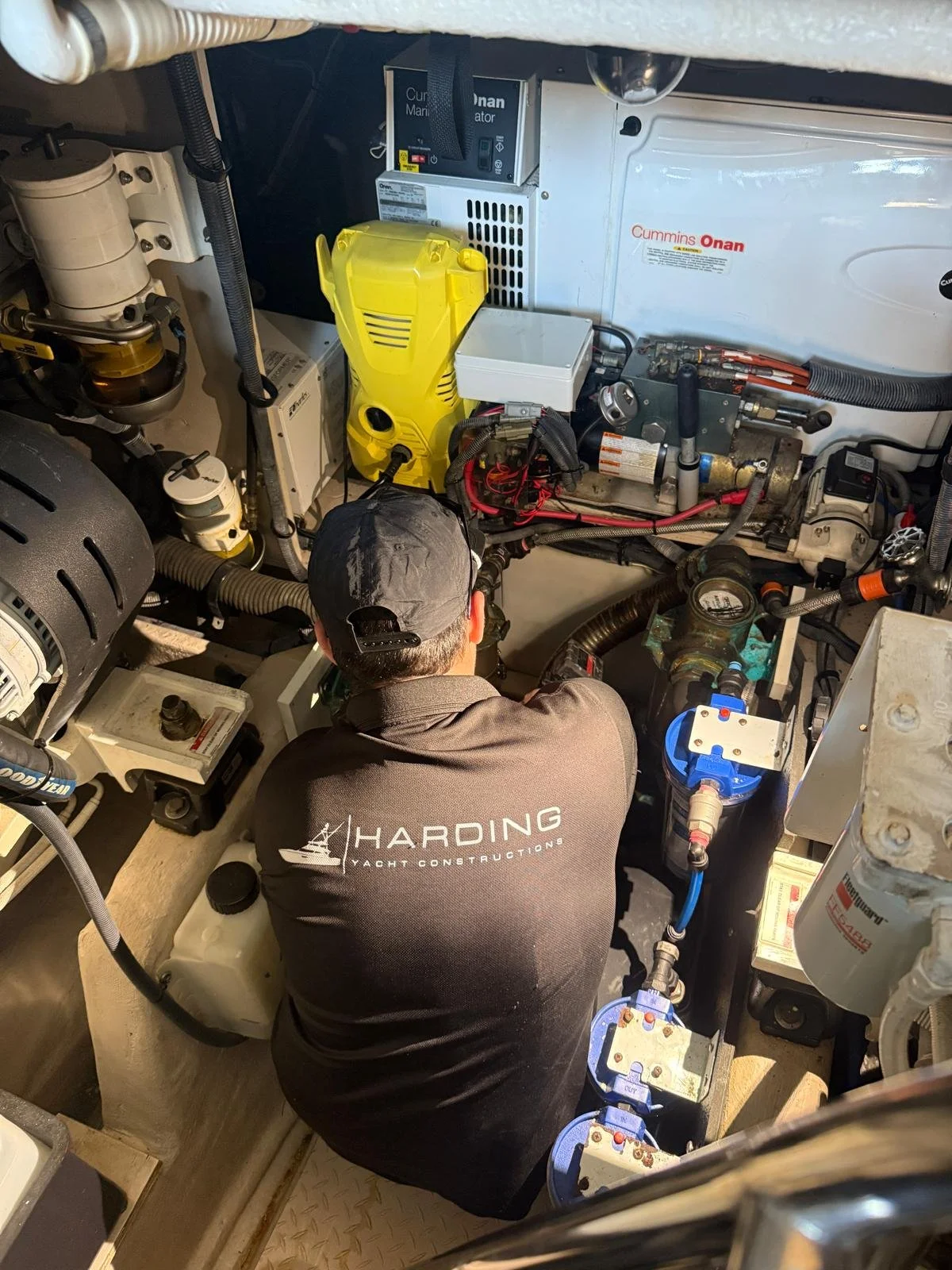 Bailey Harding of Harding Yacht Constructions carrying out engine room works aboard a Sea Ray 515 Sundancer motor yacht at Gold Coast City Marina on the Gold Coast, Queensland