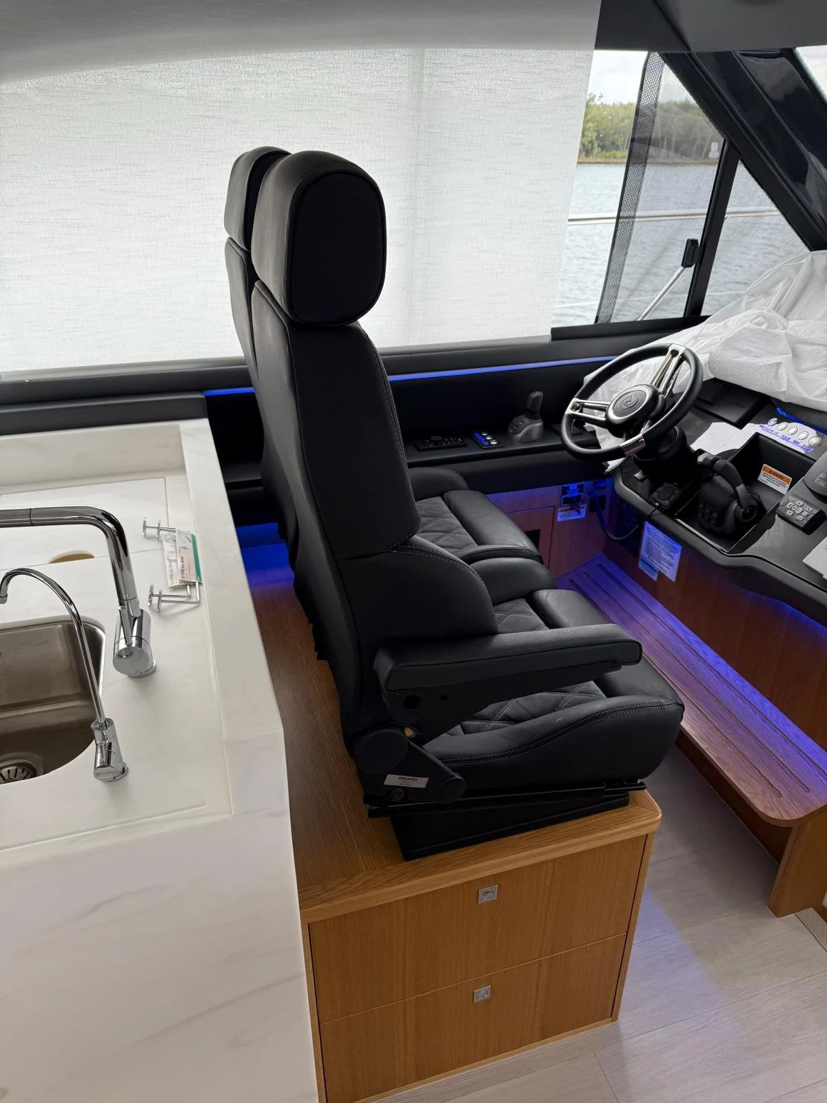 Custom helm seating modification to improve forward visibility on a Riviera 4600 Sport Yacht