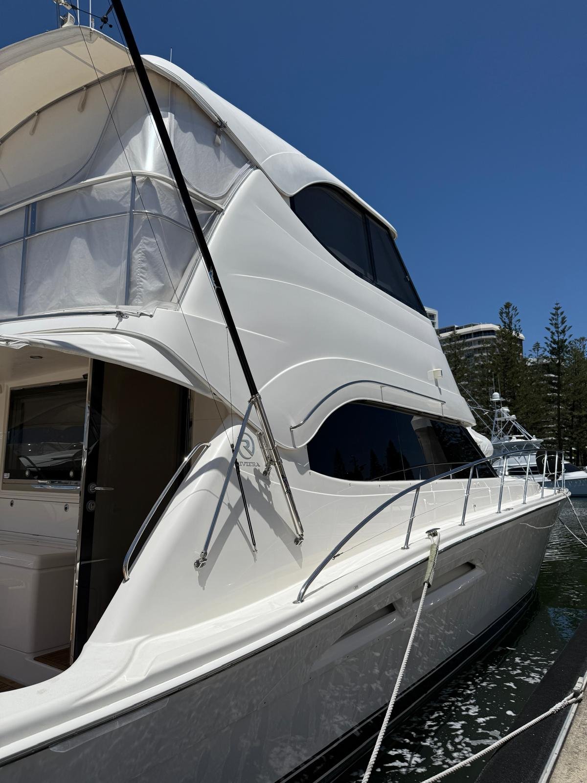 Riviera flybridge motor yacht berthed at marina on the Gold Coast