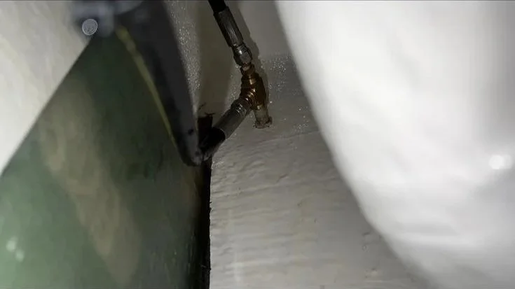 Cross-threaded high-pressure water line fitting identified as the source of a significant boat water leak during mobile leak diagnosis on the Gold Coast