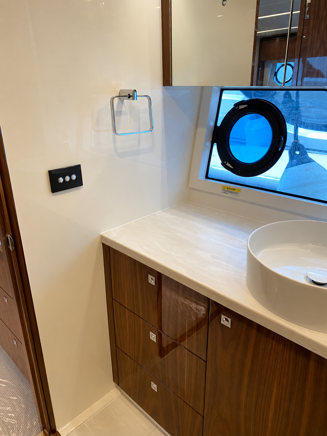 Master cabin head interior fit-out with Corian benchtop and timber cabinetry aboard a luxury motor yacht
