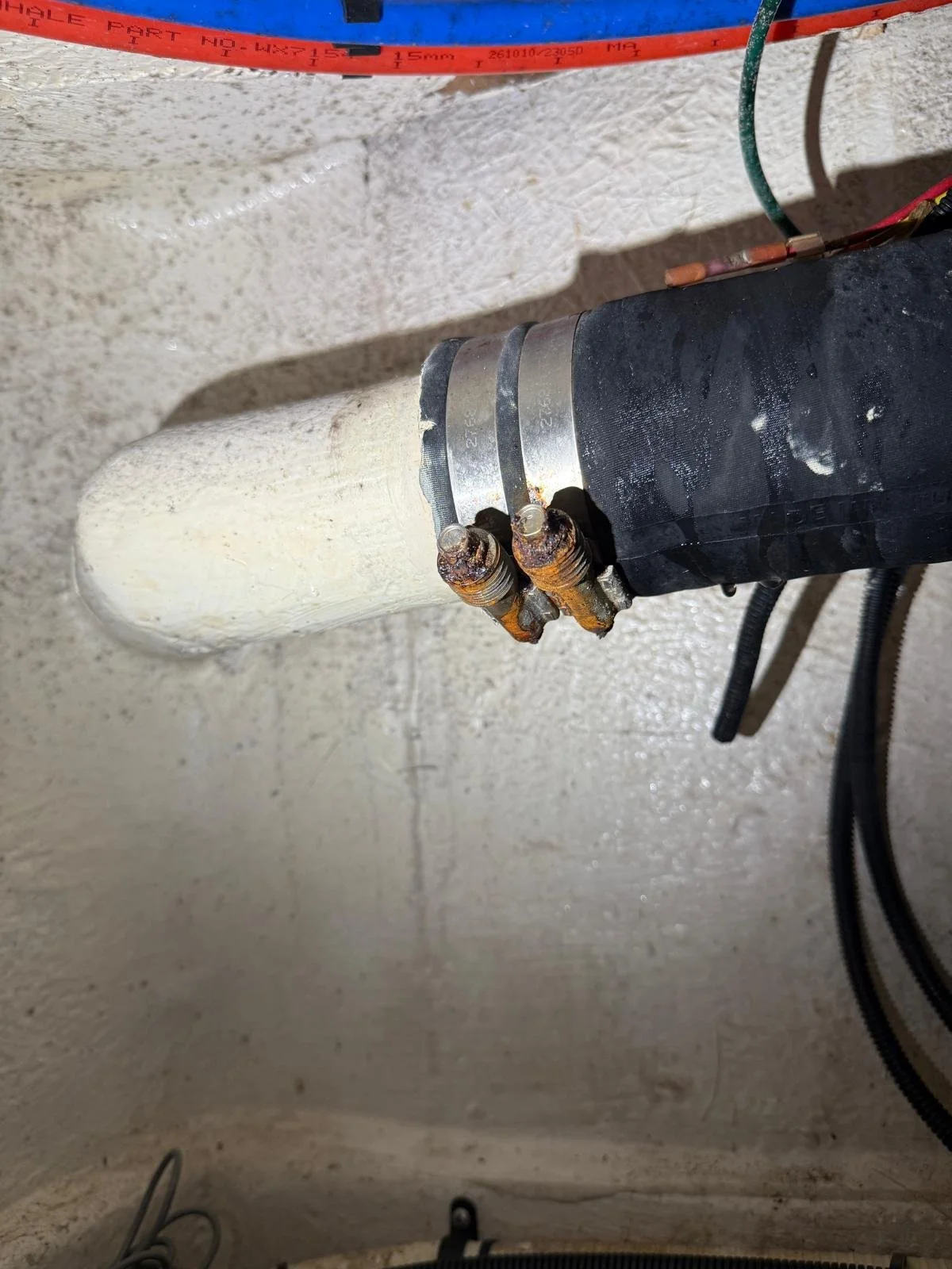 Corroded marine hose clamps and plumbing connection requiring maintenance