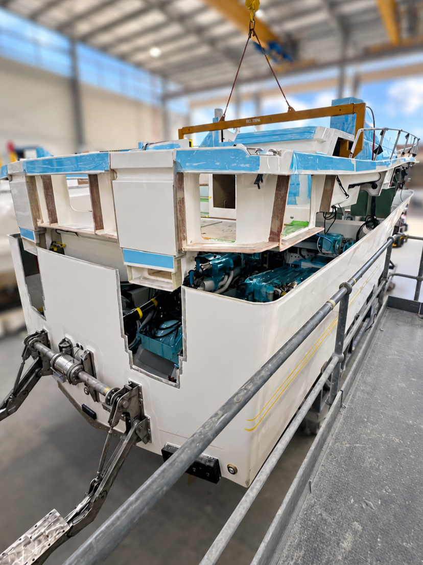 Luxury motor yacht hull and deck being joined during construction
