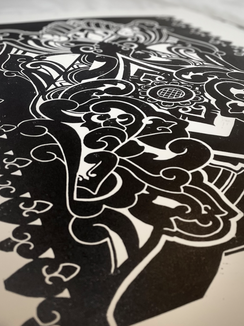 Close-up of a black and white ornate, intricate design or illustration featuring swirling patterns and detailed artwork.
