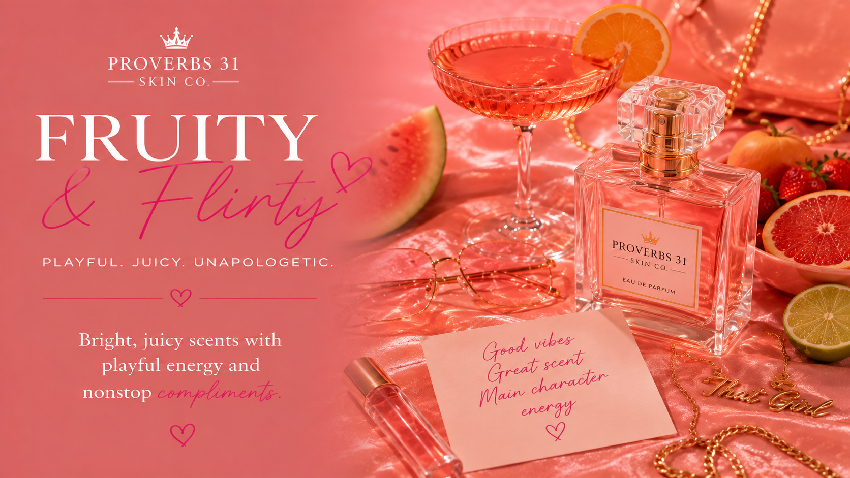 Pink promotional image for Proverb 31 Skin Co. featuring a bottle of Fruity & Flirty perfume, slices of grapefruit, lime, watermelon, strawberries, a cocktail glass with an orange slice, a handwritten note, gold chain necklaces, a small tube of lip gloss, and a pair of gold glasses on a pink satin fabric background.