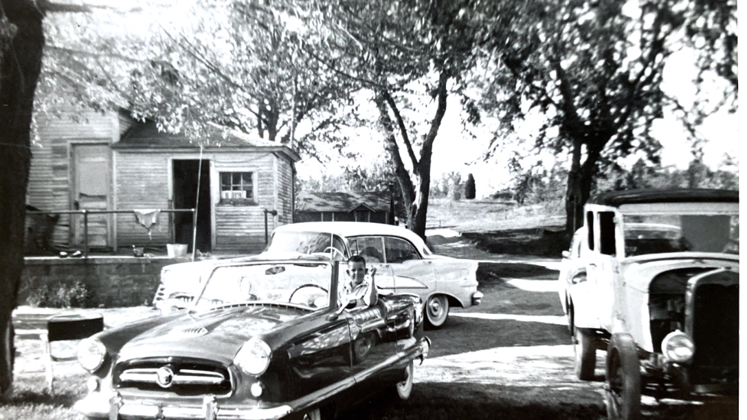 Lynn and Ben's eclectic driveway in 1955. For Ben's parents, a new Oldsmobile. For Lynn and Ben, a new British-built Nash Metropolitan, a Ford hot rod sedan from the '30s, and behind the old sedan, a new Chevy. (Photo courtesy of Lynn Lewis) 