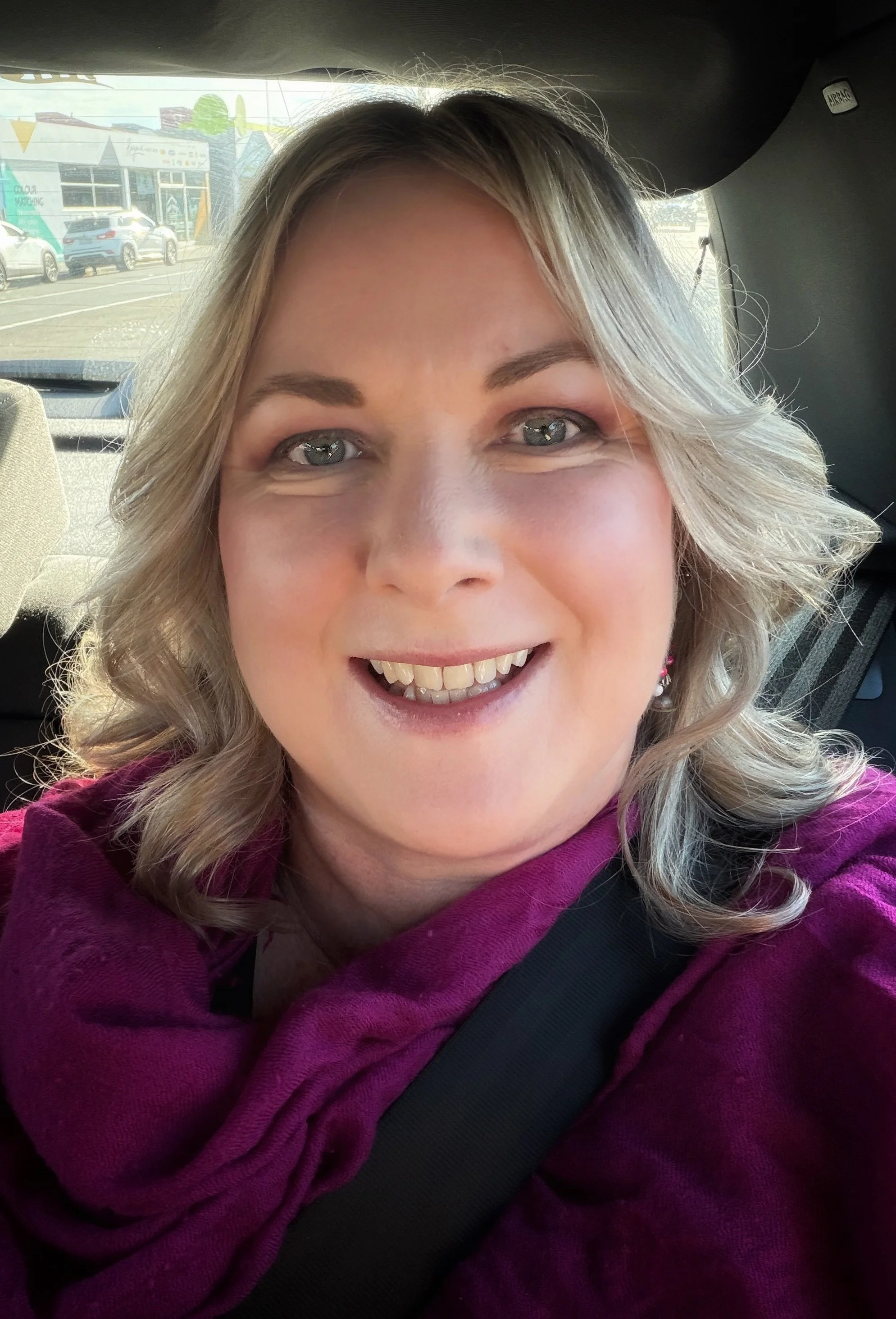 Portrait of Merryn Pyper, Founder and Creative Director of Jade House Studio, smiling in a fuchsia pashmina.