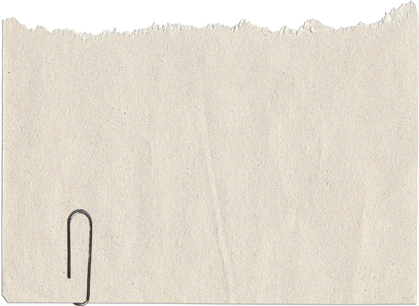 A torn piece of beige paper with a metal paperclip attached to the bottom left corner.
