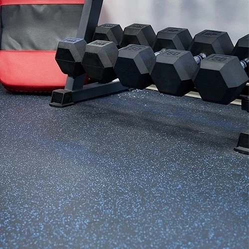 Set of black dumbbells on a rack in a gym with a speckled rubber flooring.