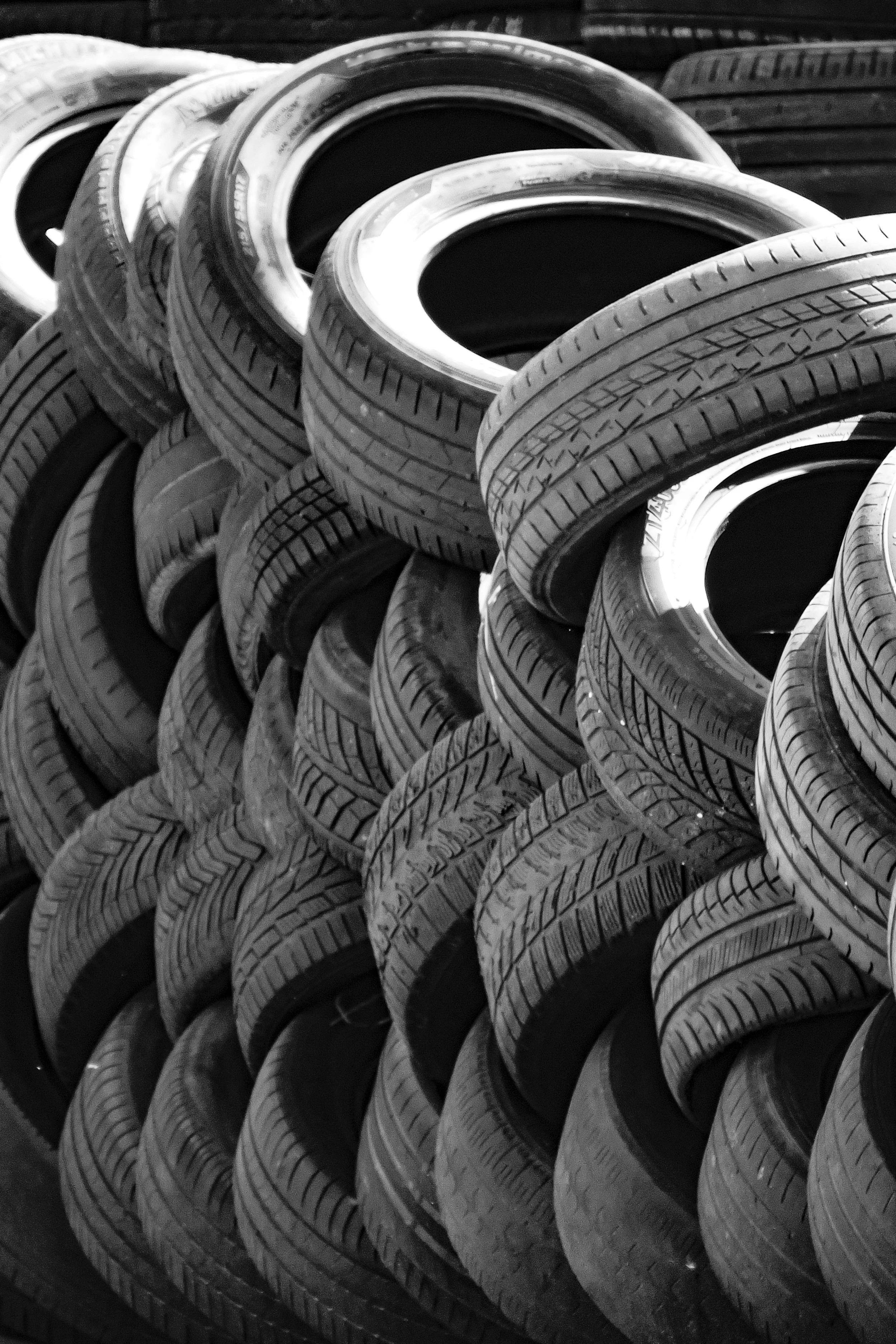 Stacked car tires with visible treads.