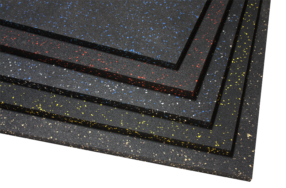 Stacked black rubber mats with multicolored speckled patterns in yellow, white, red, and blue.