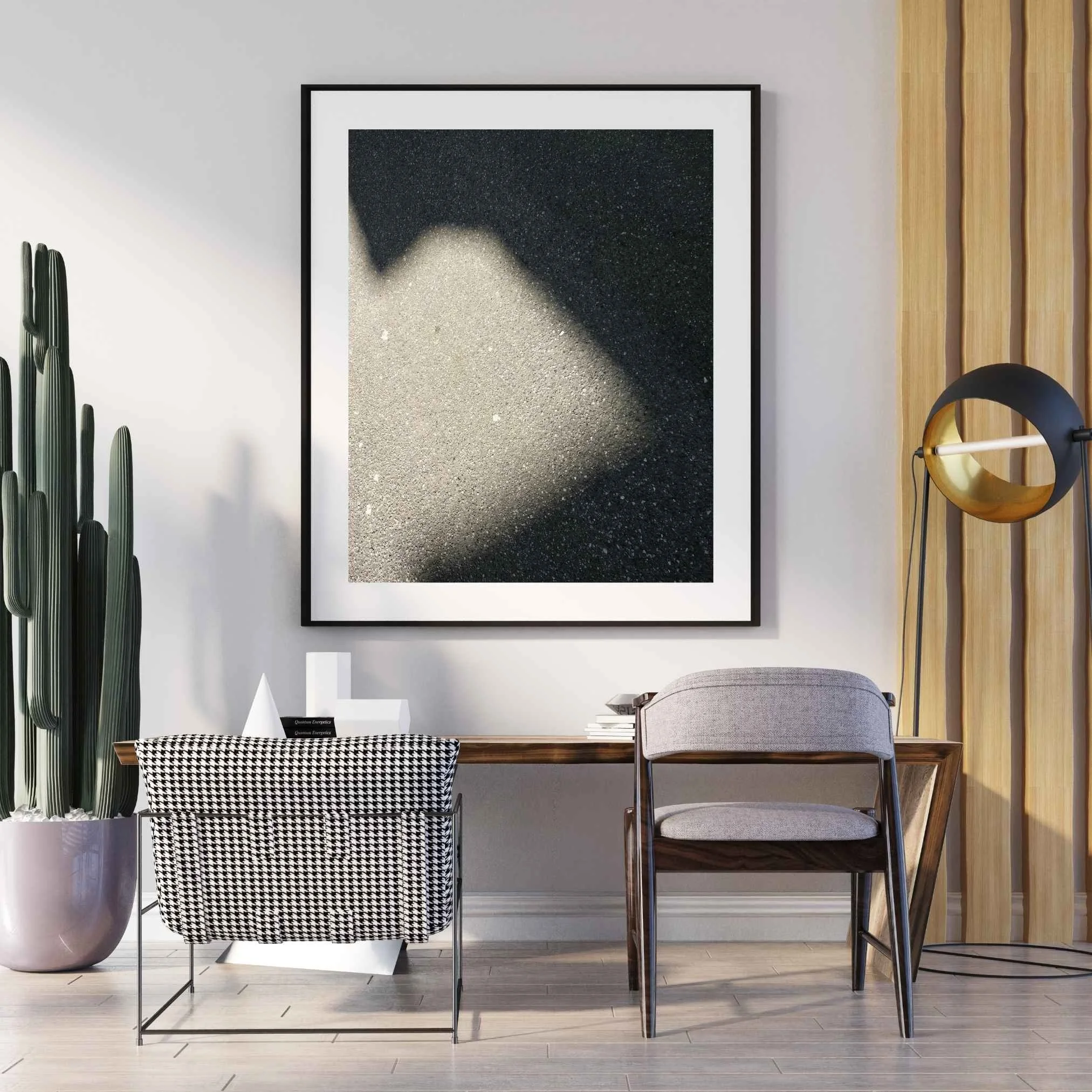 Interno moderno con sedie di vari materiali e design, decorazione minimalista che include una stampa d'arte nei toni del grigio e una pianta in vaso di grandi dimensioni.