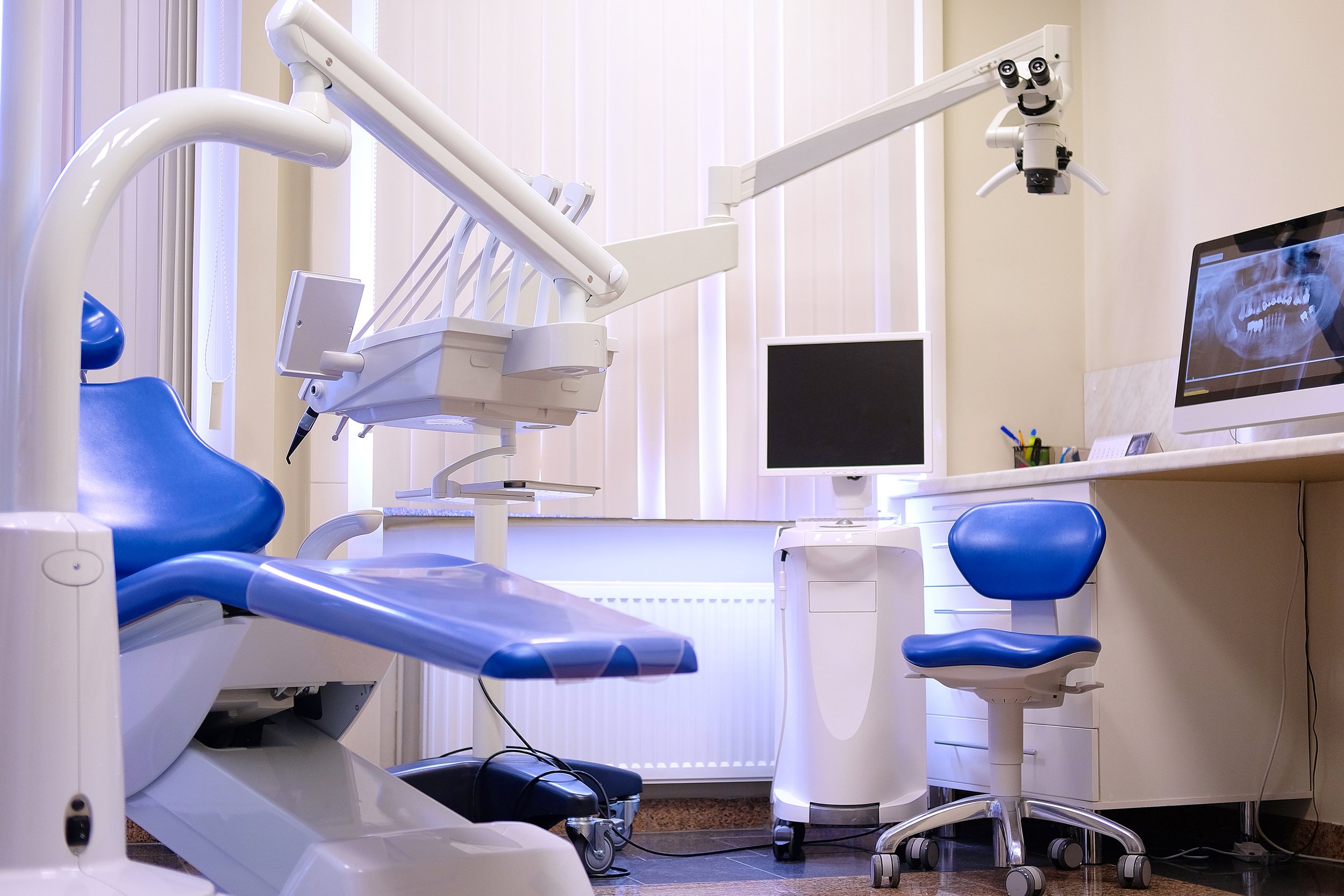 Dental examination room with dental chair, computer, and dental equipment