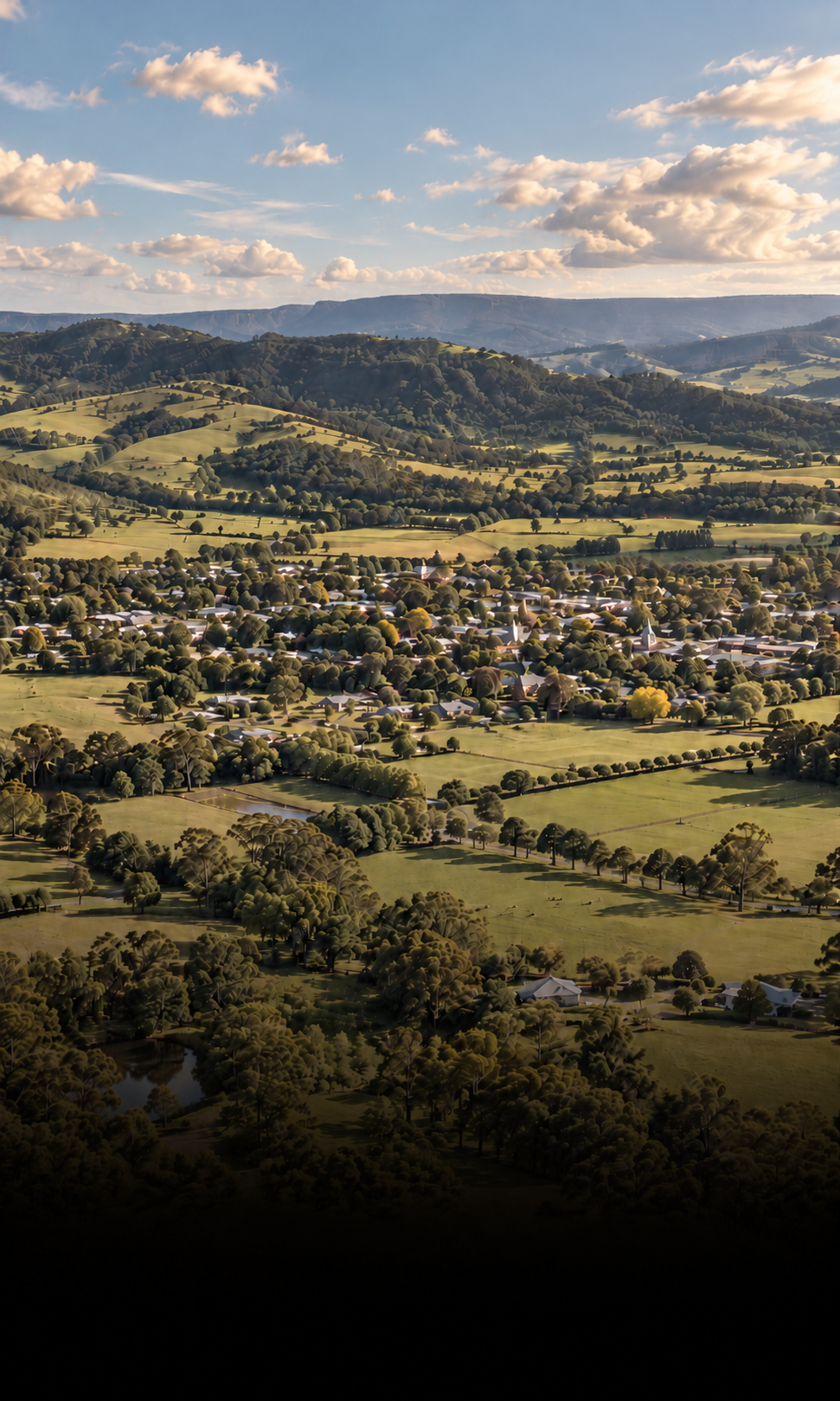 Aerial view of Berry NSW surrounded by green farmland and South Coast countryside