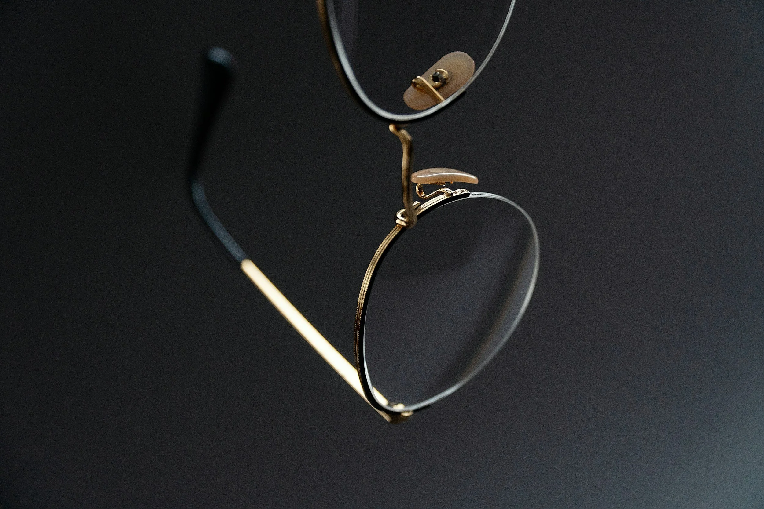 Close-up of a pair of eyeglasses with a black background.