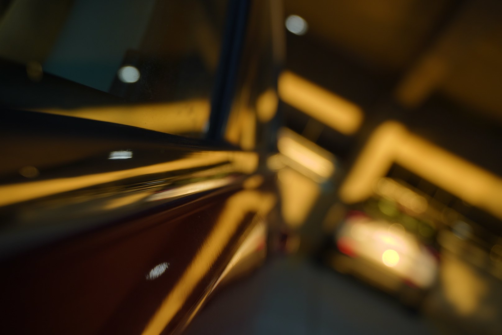 Abstract photo of the side of car with glowing golden light reflecting of it's exterior