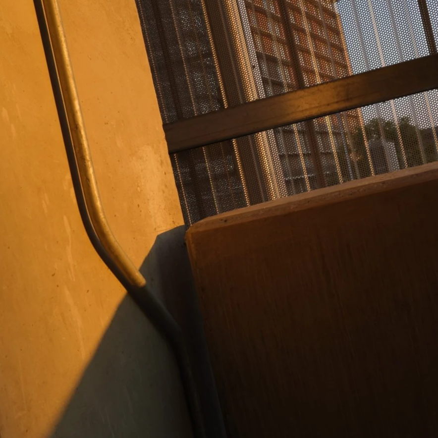 Close-up of a concrete barrier with a slight view of a city