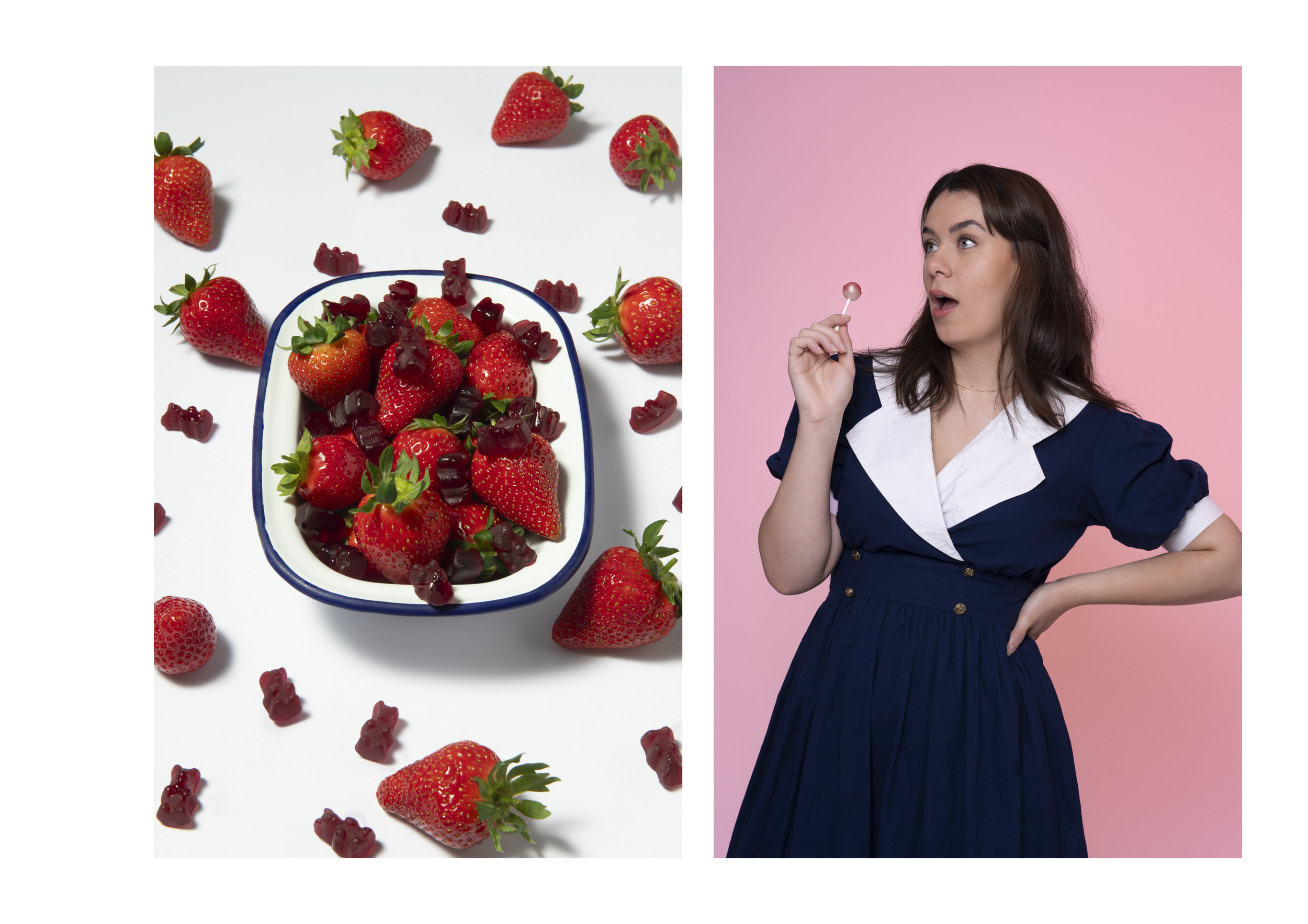 Several fresh strawberries and red gummy candies scattered around a blue and white dish, with a woman in a navy dress holding a pink lollipop against a pink background.