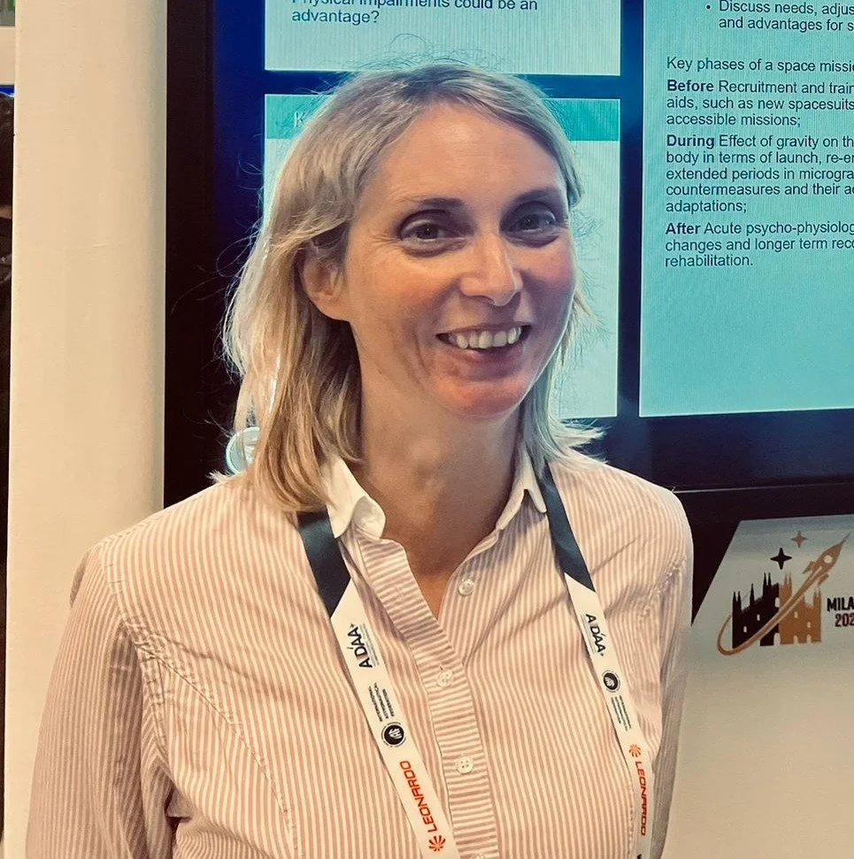 Irene smiling in front of her interactive poster at IAC 2024, Milan