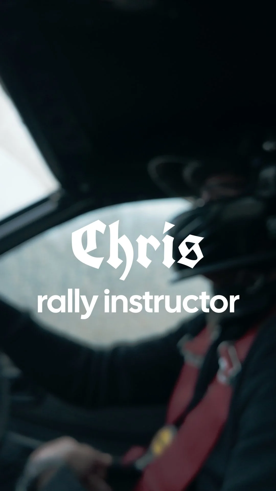 Interior of a vehicle with a person wearing a red harness, with text overlay reading 'Chris rally instructor'.