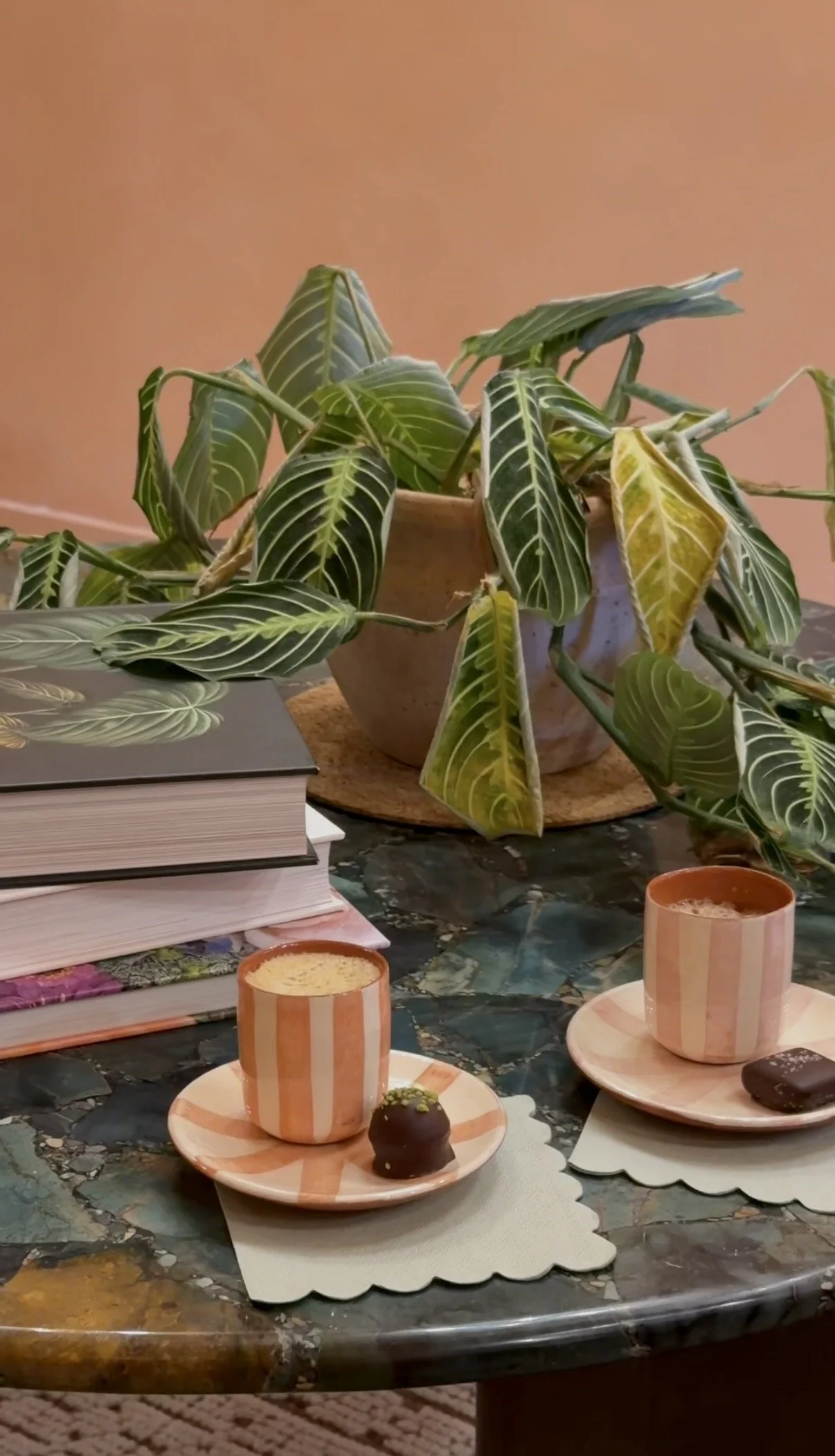 Relaxing wellness-inspired setting with coffee, books and greenery.