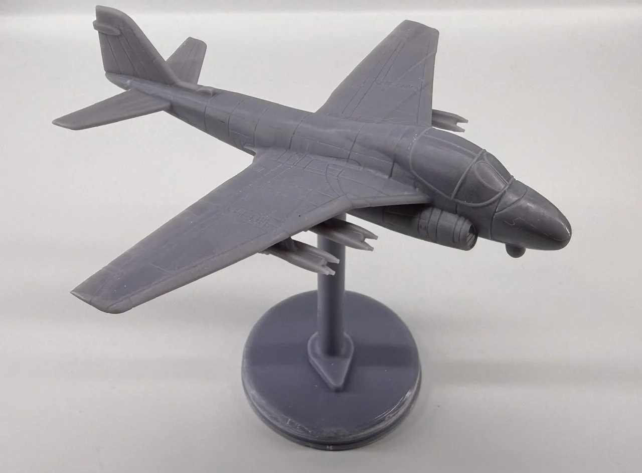 Gray plastic model airplane on a stand.