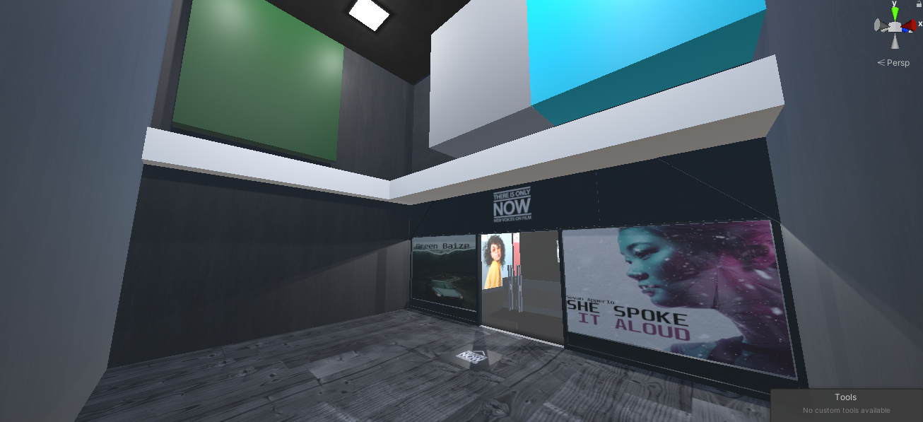 Interior view of a modern building lobby or hallway with artworks and posters, including one featuring a woman with the text "SHE SPOKE IT ALOUD".