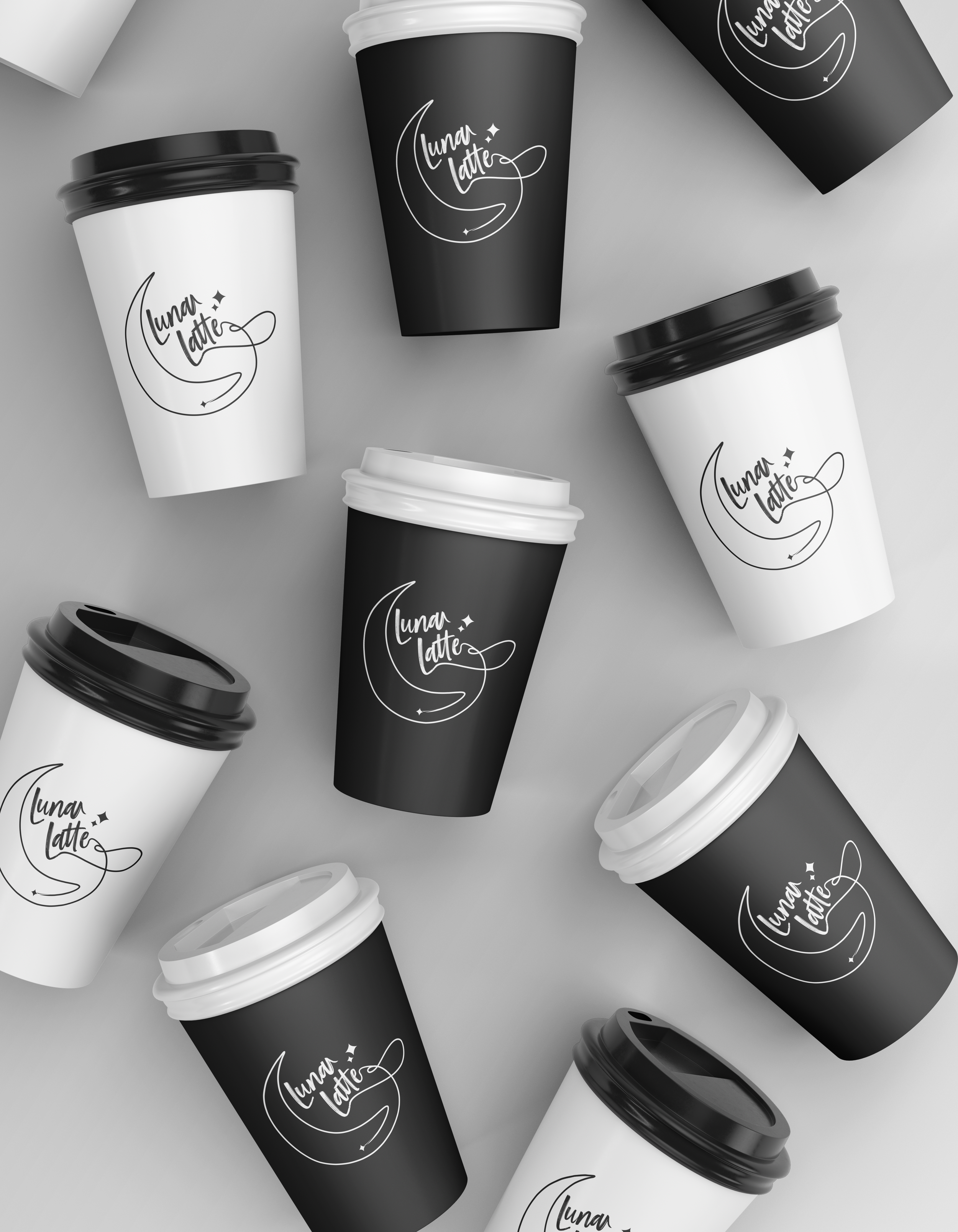Multiple paper cups with lids, some black and some white, featuring a logo that reads "Luna Latte" with a moon and stars design, on a gray surface.