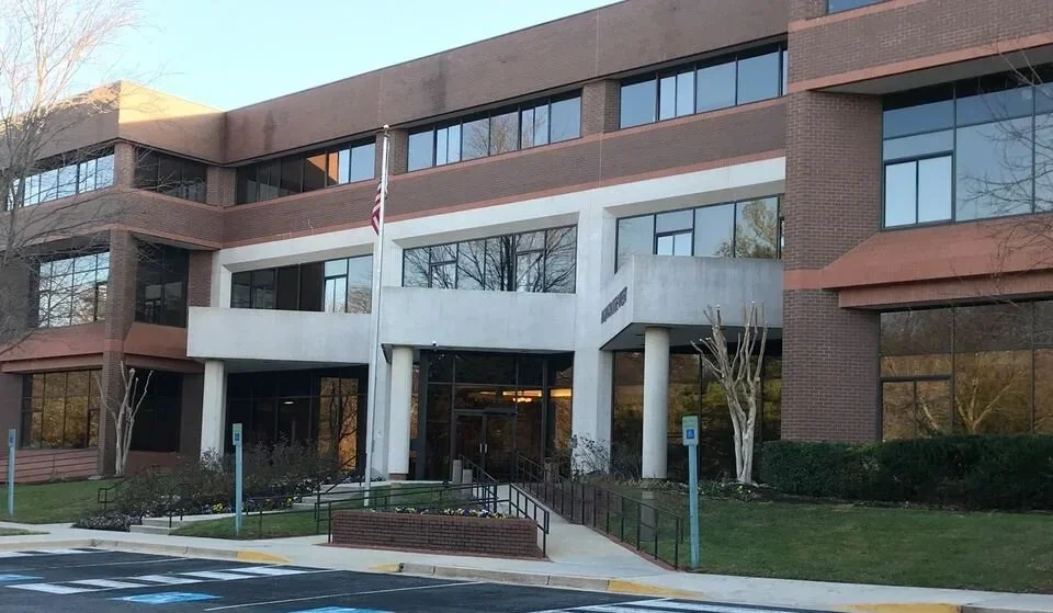brick office building with flag in front