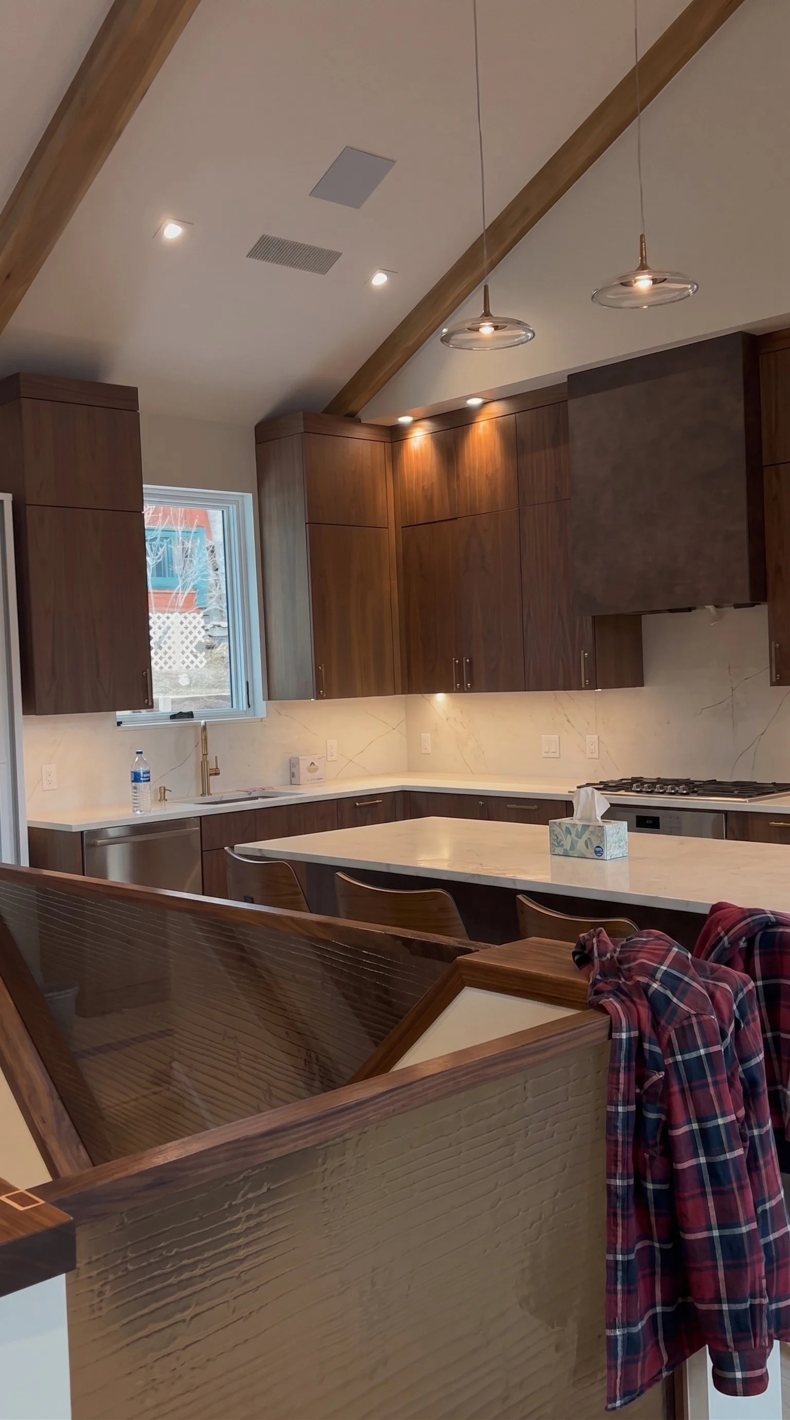 Professional residential kitchen cleaning services showcasing a spotless modern kitchen with wooden cabinets and marble countertops.