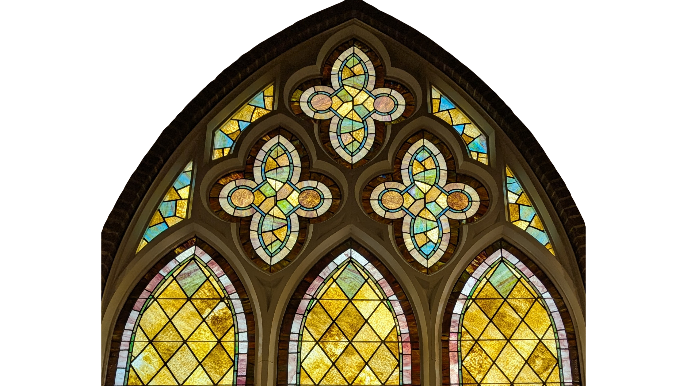 Colorful stained glass window with intricate designs and patterns in a church or cathedral setting.