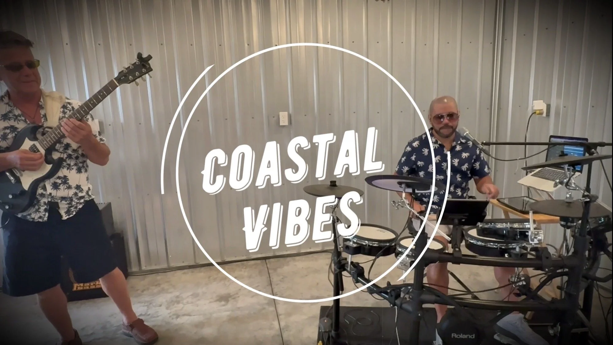 The musician on the left Dale Neville plays an electric guitar. The musician on the right James Rodriguez plays electronic drums. Picture of the video shoot.