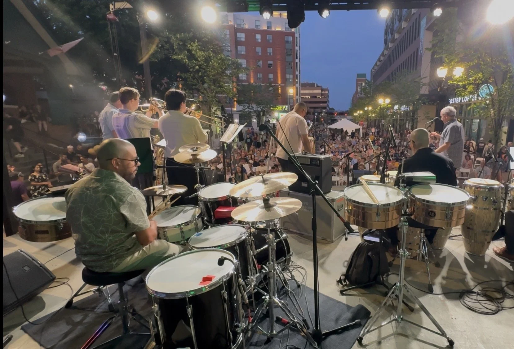 James Rodriguez performing at the Summer Soltice Jazz Festival. The band includes a drummer, trumpet players, and other musicians.