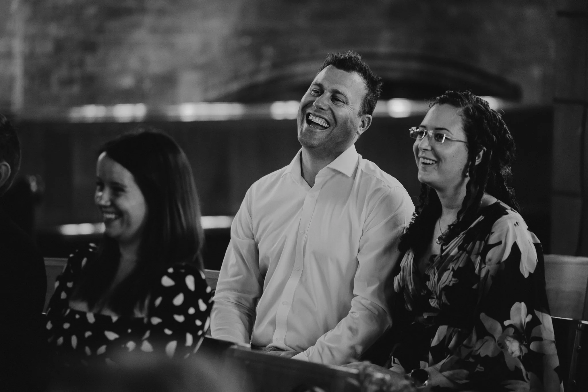  Guest laughing during the ceremony at All Saints Church in Hampton 
