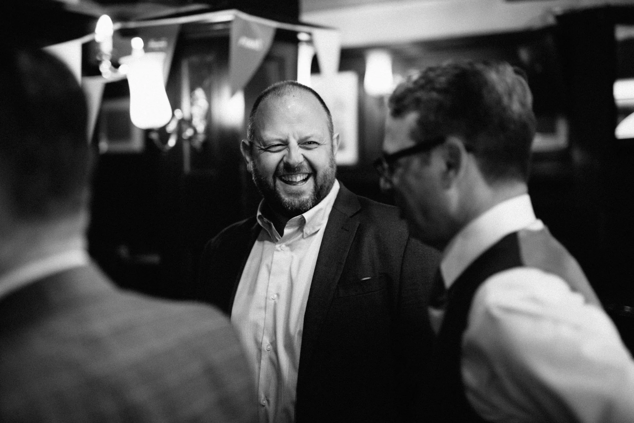  WEdding guest laughing with the groom 