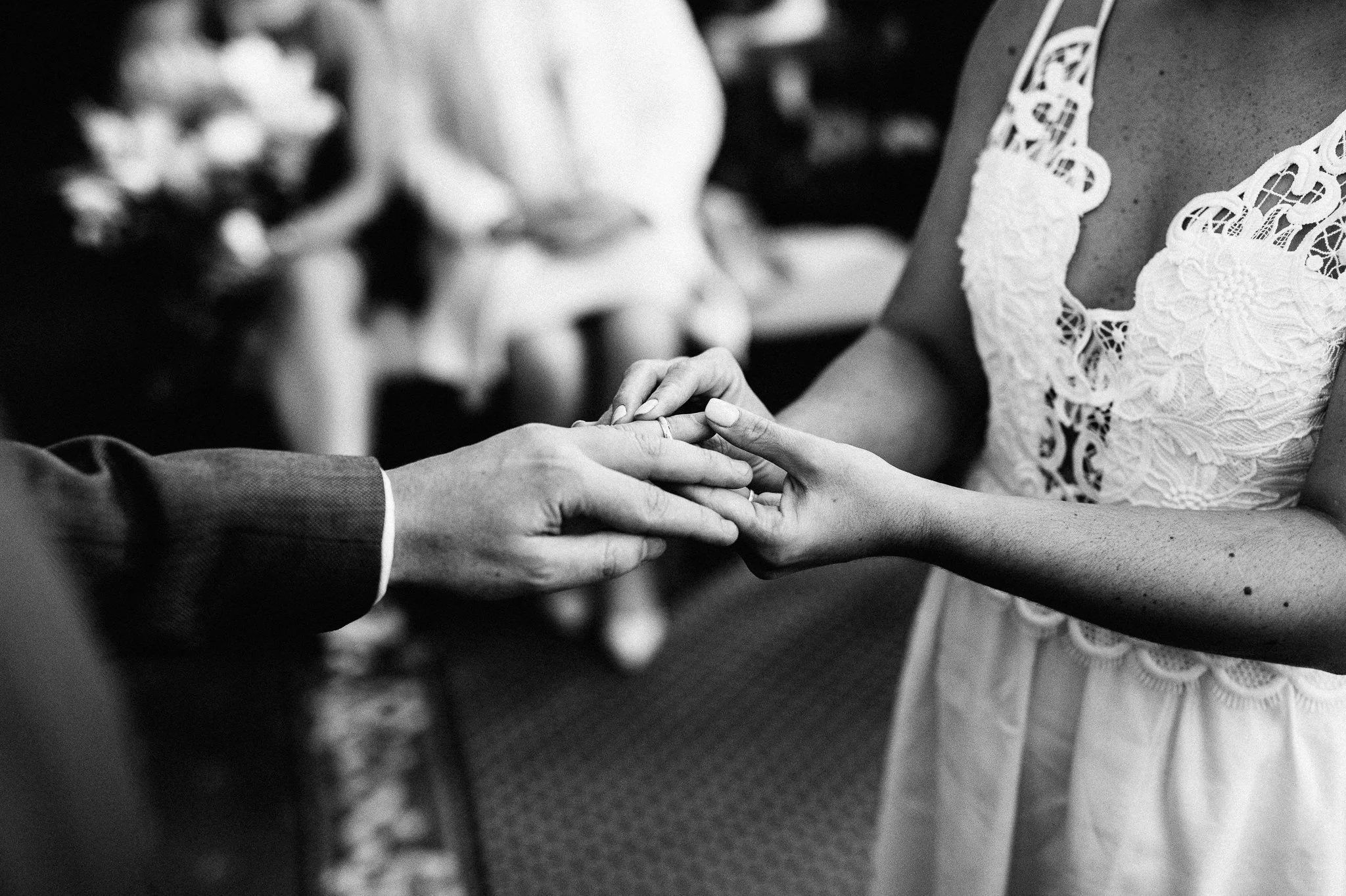  Bride places a wedding ring on the grooms finger at The Mansion 