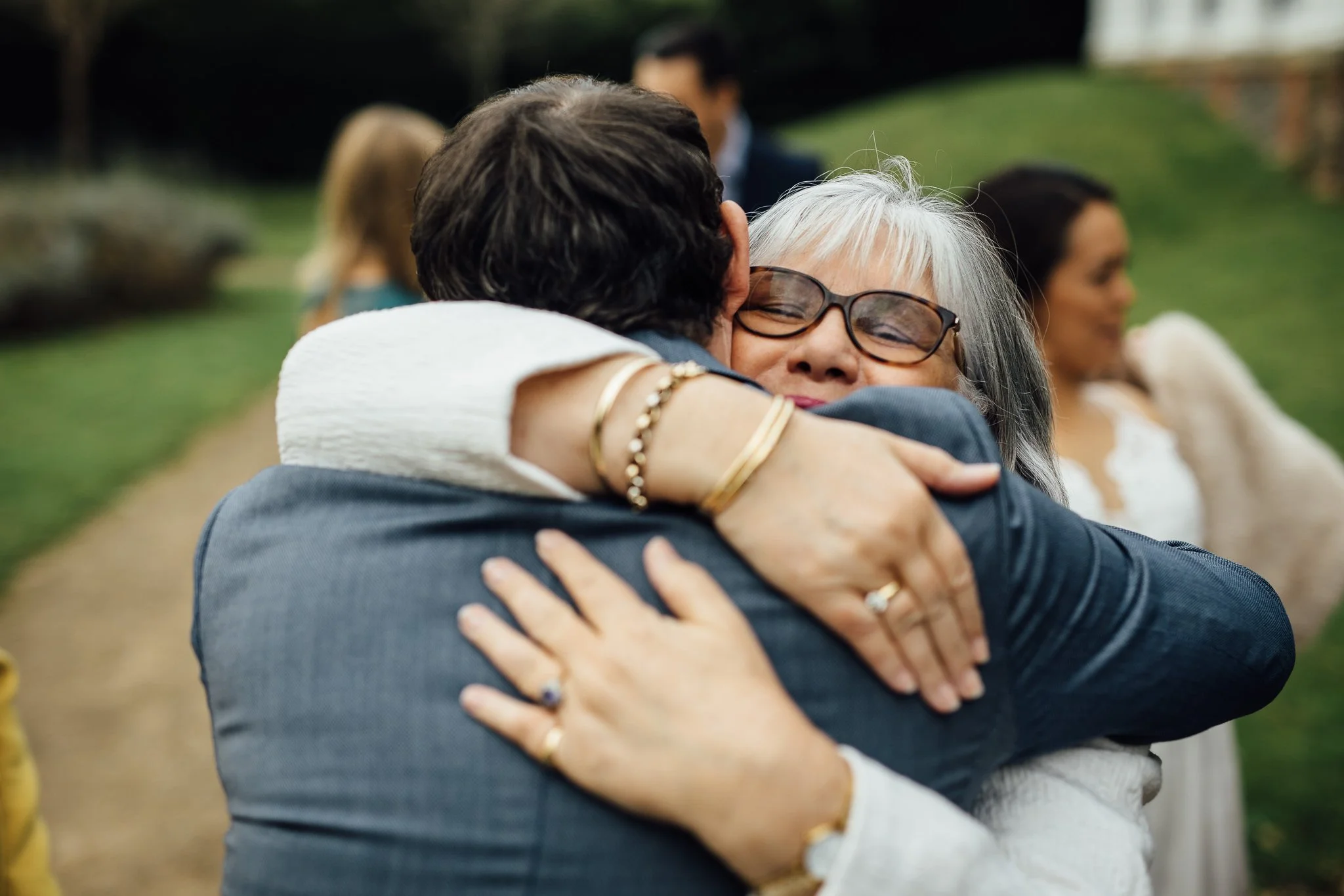  Mother of the Bride hugs the groom after the ceremony 