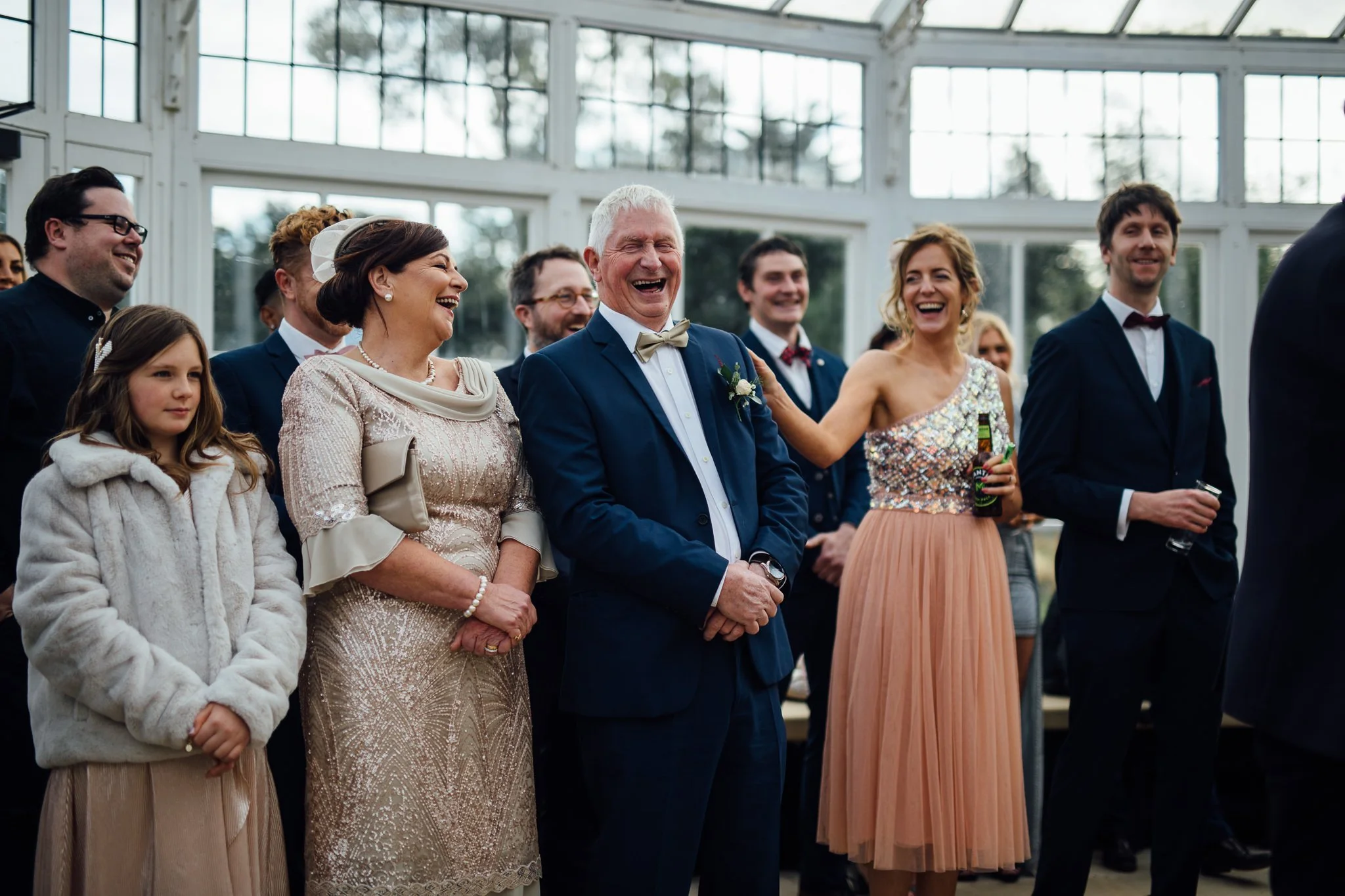 Wedding guests laughing during the speeches 