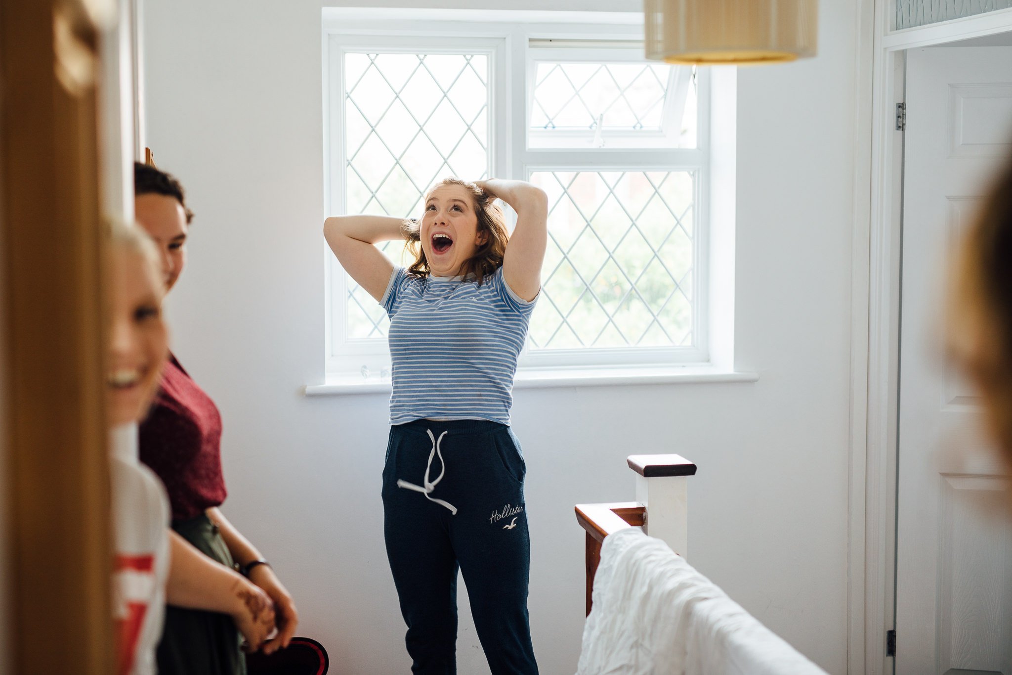  Bridesmaids react in shock after seeing the bride in her wedding dress 
