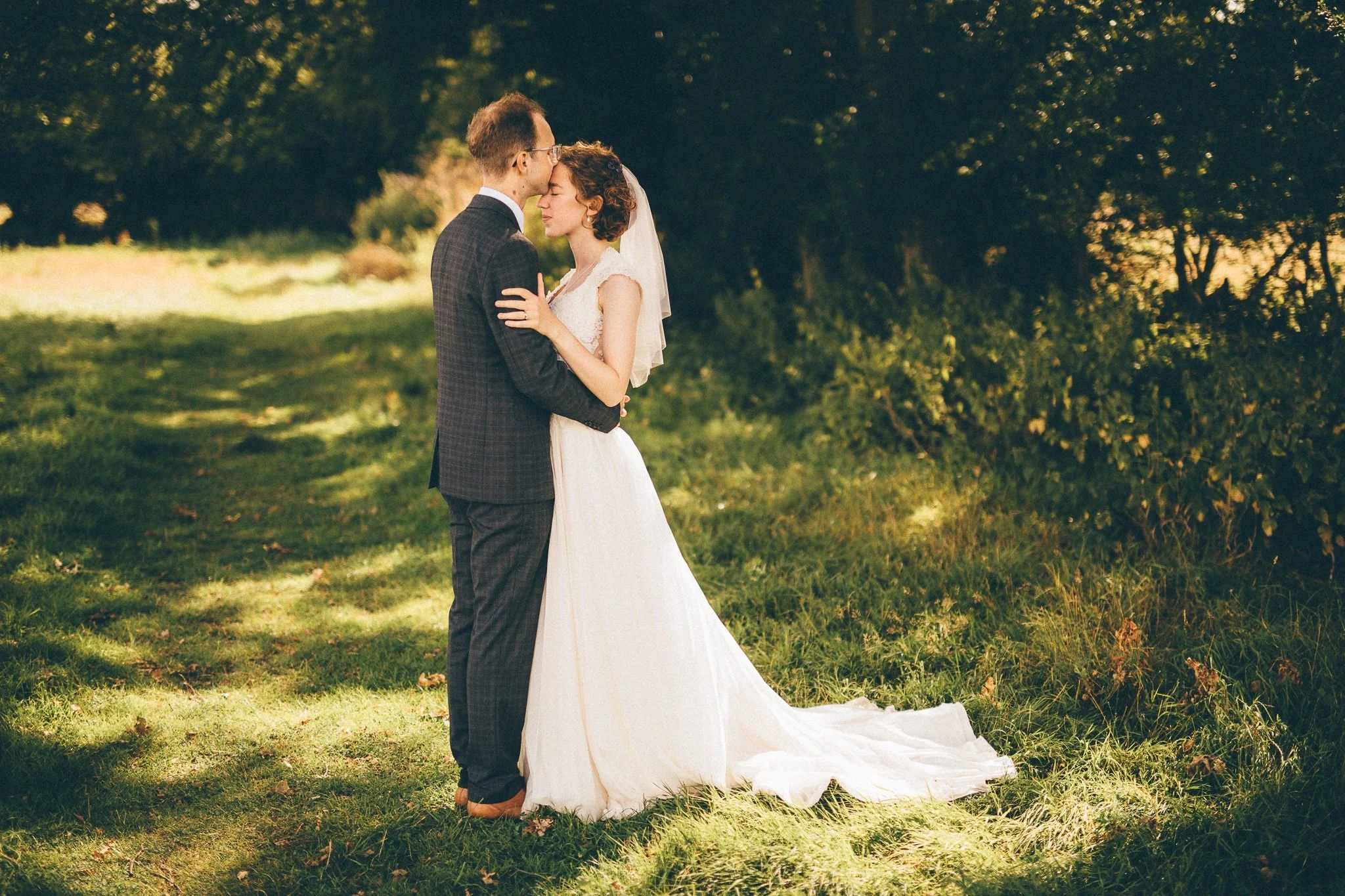  Groom kisses the Bride on the forehead 
