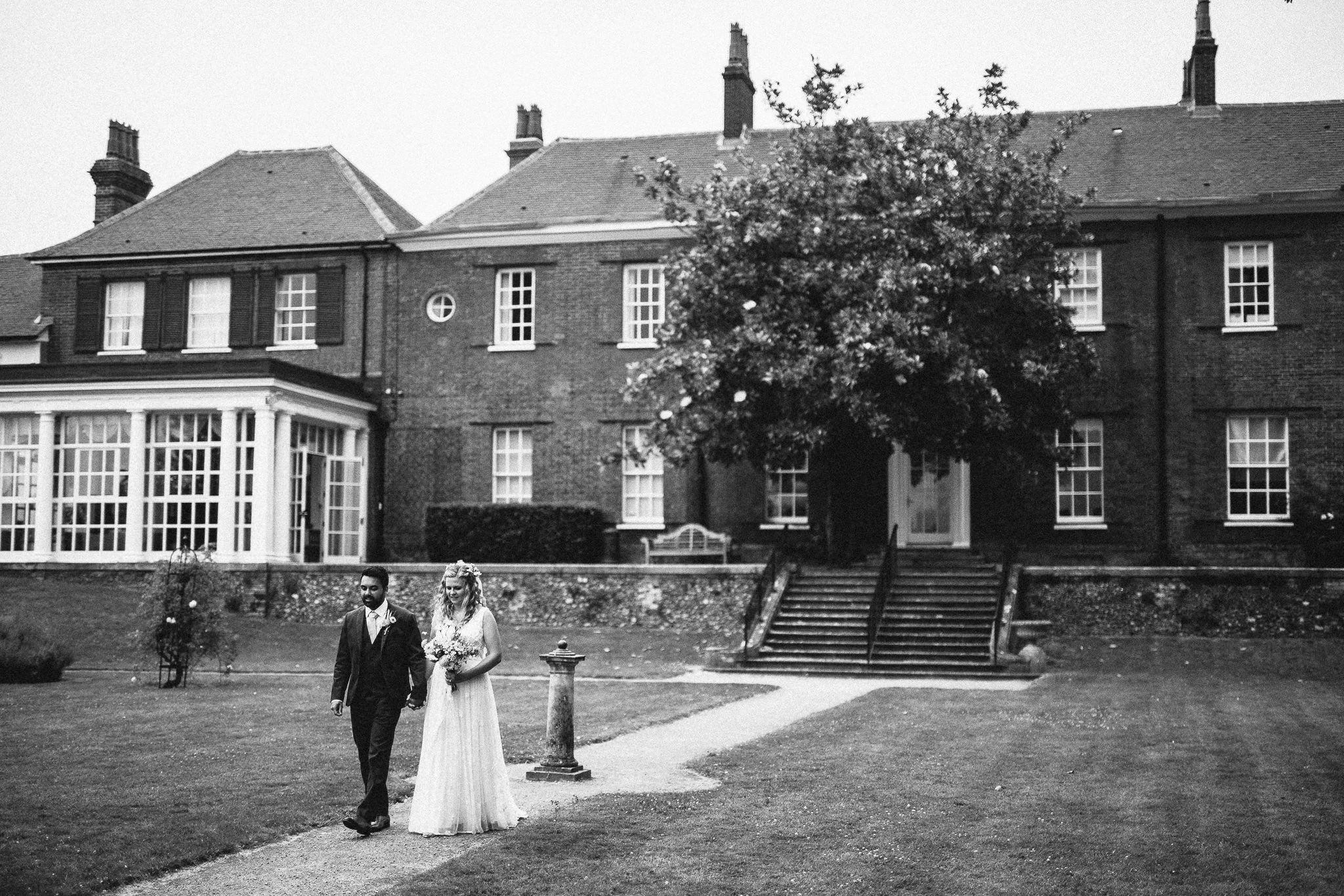  Bride and Groom walk around the gardens at Leatherhead Register Office 