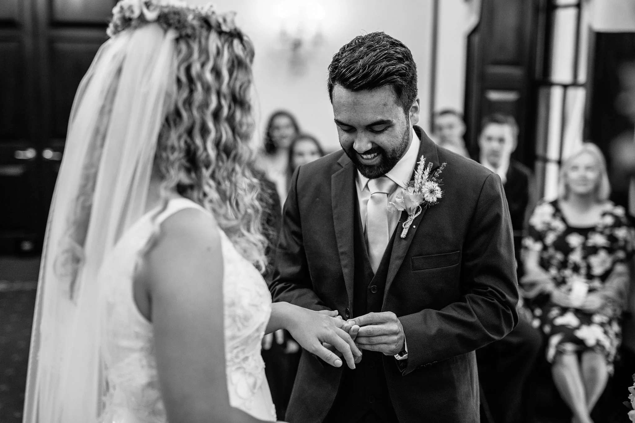  Groom putting the ring on his Bride’s finger at Leatherhead Register Office 