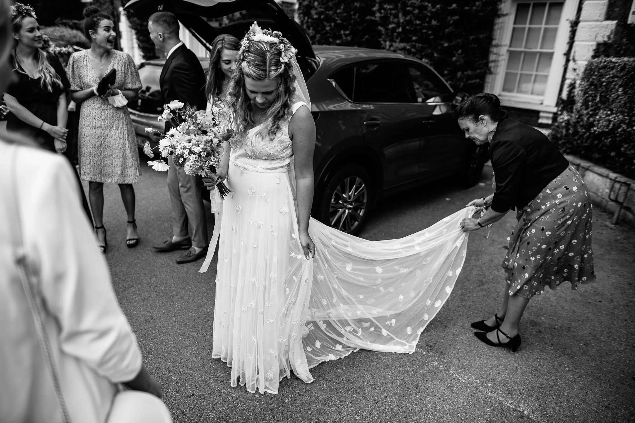  Mother of the Bride sorts at the Bride’s dress in the car park at Leatherhead Register Office 