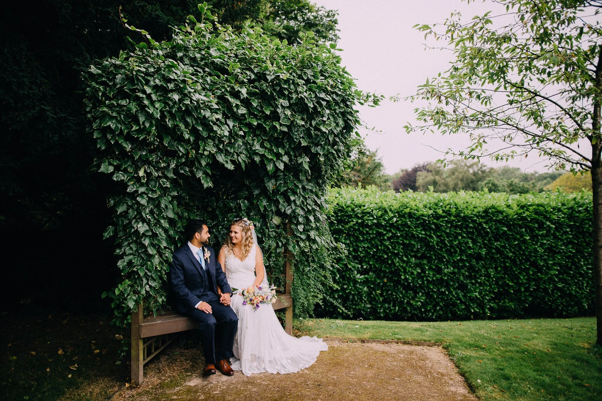  Bride and Groom sitting in the gardens at Leatherhead Register Office 