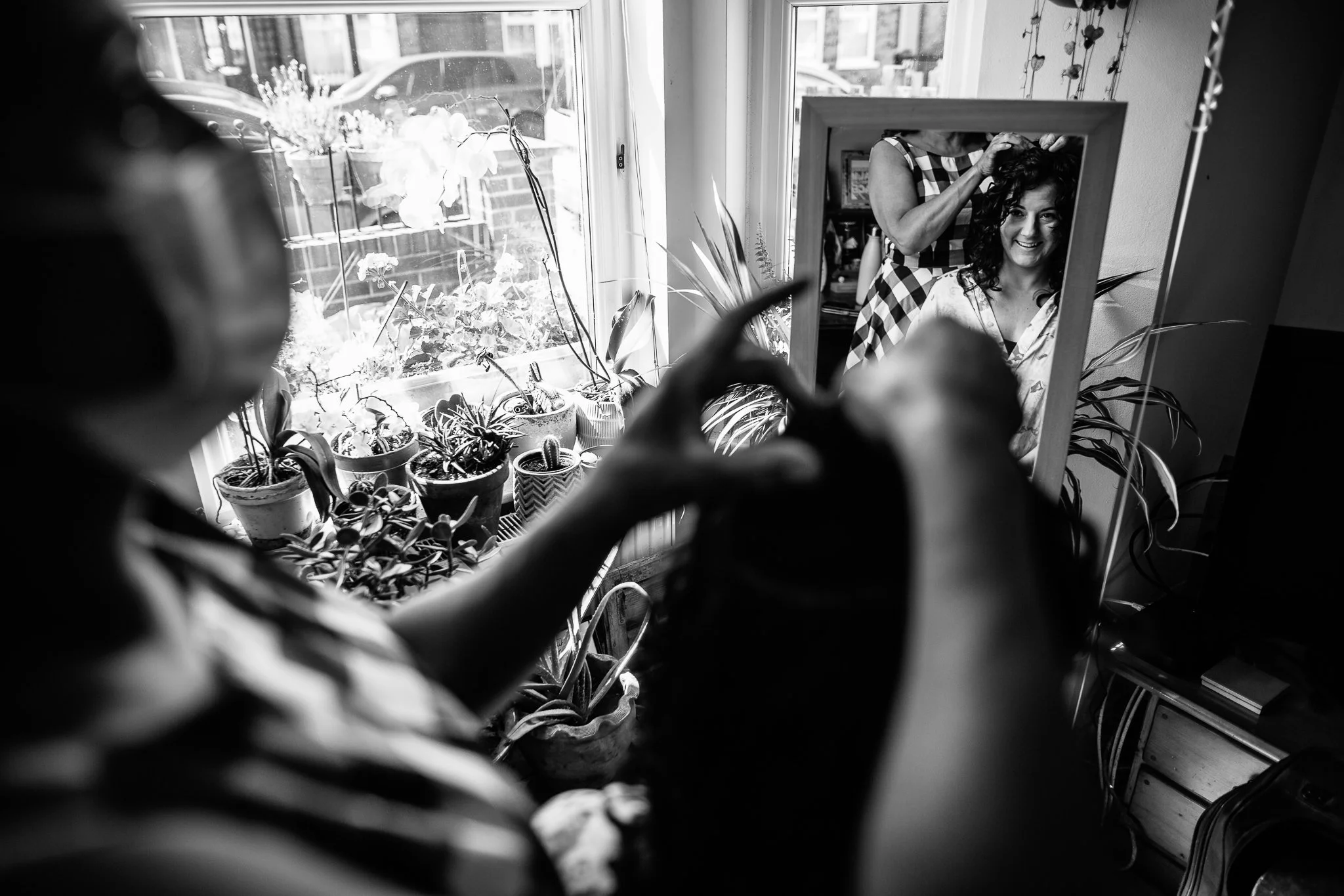  Bride looking in the mirror as she prepares for her wedding day 