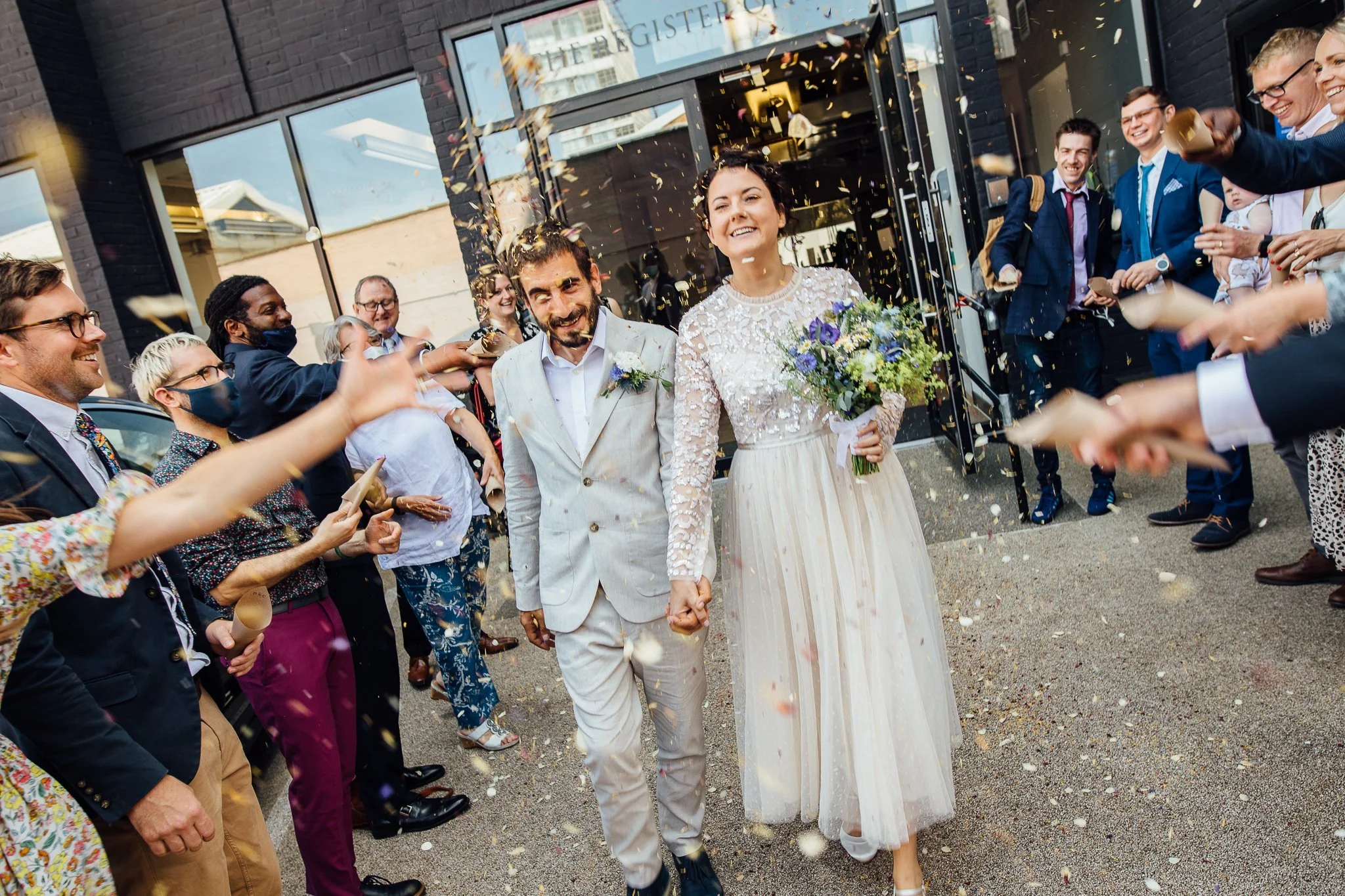  Bride and Groom have confetti thrown at them at Hammersmith Register Office. 