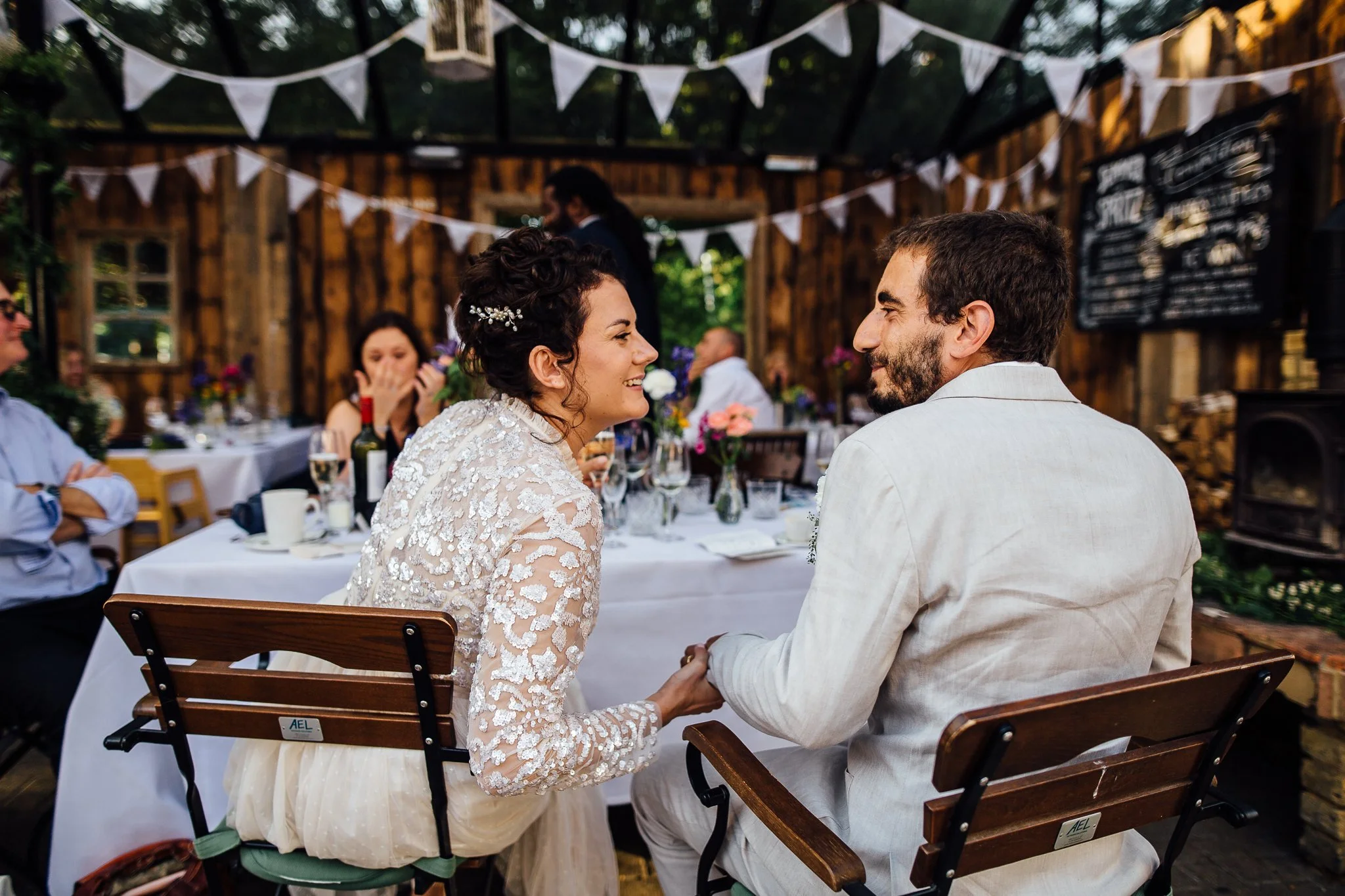  Bride and Groom looking at each other during the wedding breakfast after being married at Hammersmith Register Office. 
