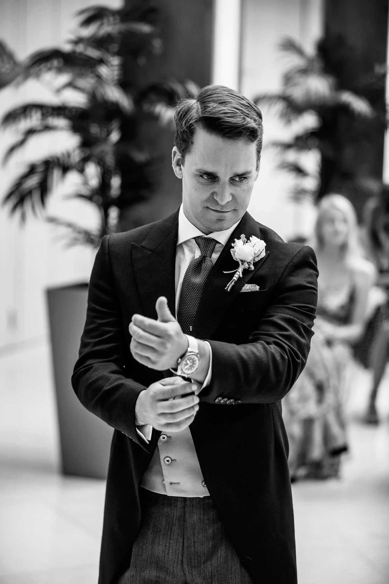  Groom adjusts his cufflinks before the wedding ceremony at Hurlingham Club 