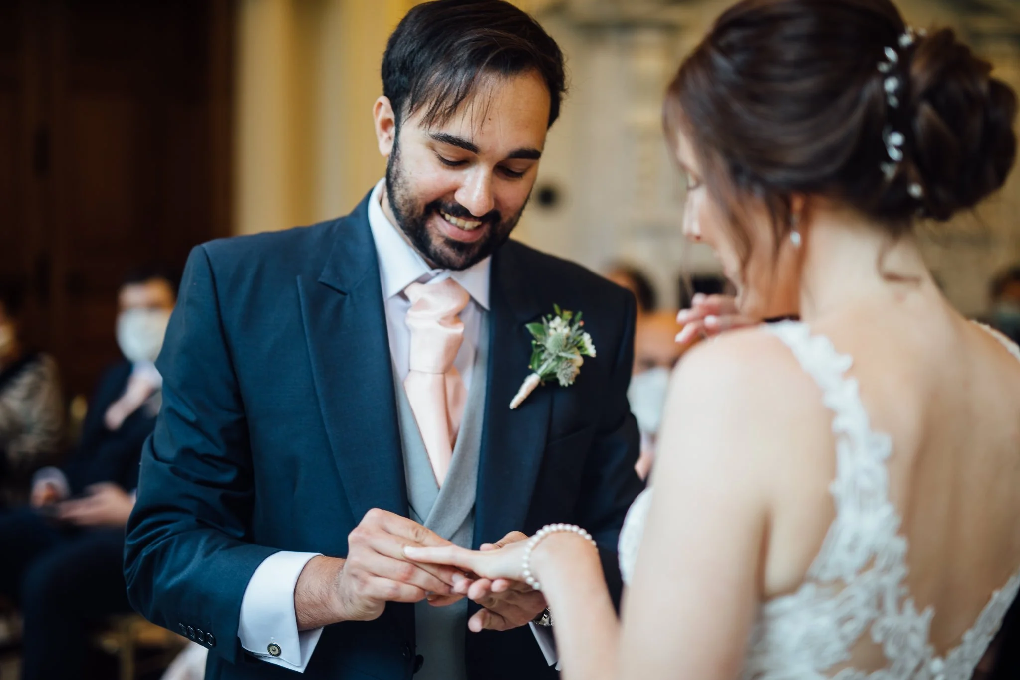  Groom places ring on the finger of his bride at Orleans House Gallery 